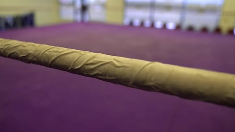 This close up video shows a panning view of wrestling ring boxing ropes.