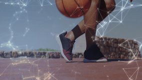 Animation of constellations over low section of fit african american senior man playing basketball. sport and healthy, active retirement lifestyle and technology concept digitally generated video.