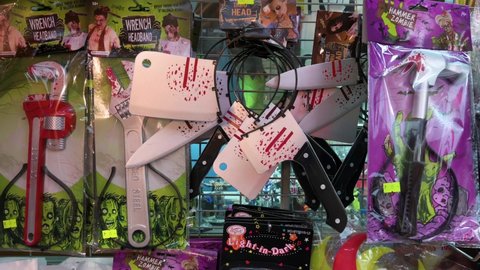 Hong Kong , Kowloon , China - 10 25 2021: Halloween theme accessory costumes, such as bloody knives, hammers, and wrenches, are seen for sale at a stall days before Halloween in Hong Kong.