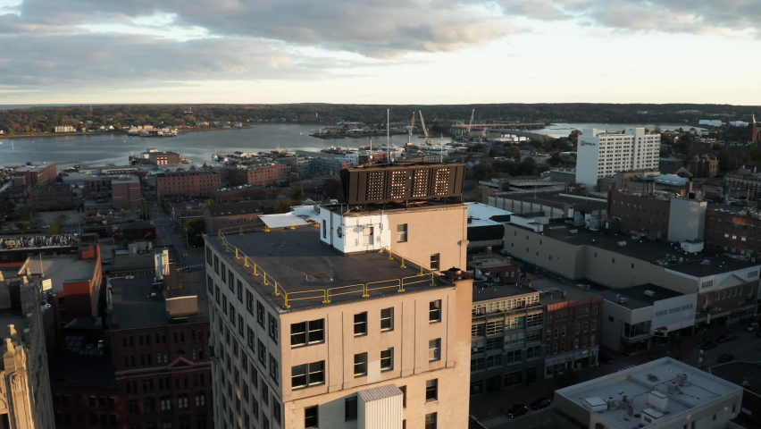 Beautiful oscillating aerial shot of the Time and Temperature building in front of Casco Bay in Portland, Maine.