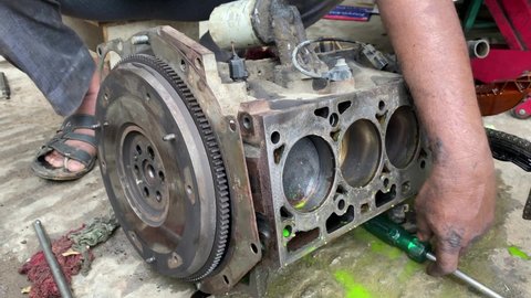 Engine flywheel disassemble by mechanic for repair. Car engine repair 