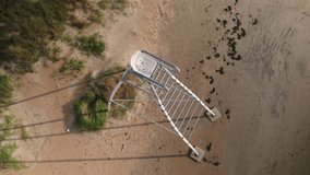 Aerial view of a tall lifeguard chair on a beach in Falkenberg, Sweden. 4K drone footage.
