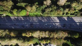 Aerial of cars braking in front of a road junction on road 158 in Gothenburg on a sunny autumn day. 4K drone footage.