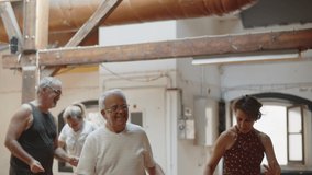Long shot of happy people dancing and having fun in ballroom. Senior dancers having good time with instructor during morning training, celebrating, spending time together. Dance class, team concept - Powered by Shutterstock - Get 15% off with code: PIKWIZARD15
