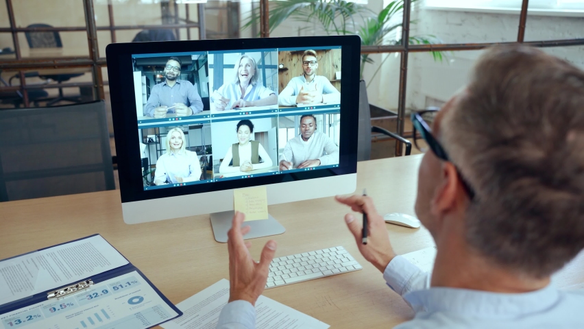 Corporate leader manager leading videoconference with diverse team business people having digital group video call conference working in office at online virtual meeting on pc computer. Over shoulder Royalty-Free Stock Footage #1081515698