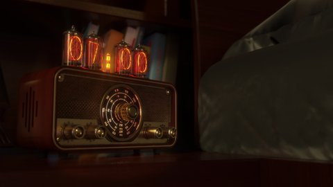 Vintage alarm clock on Nixie tubes with radio waking up at 7 AM. Close-up view. The numbers on the clock screen change from 6:59 to 7:00 AM. Then turns on the radio receiver and its scale lights up