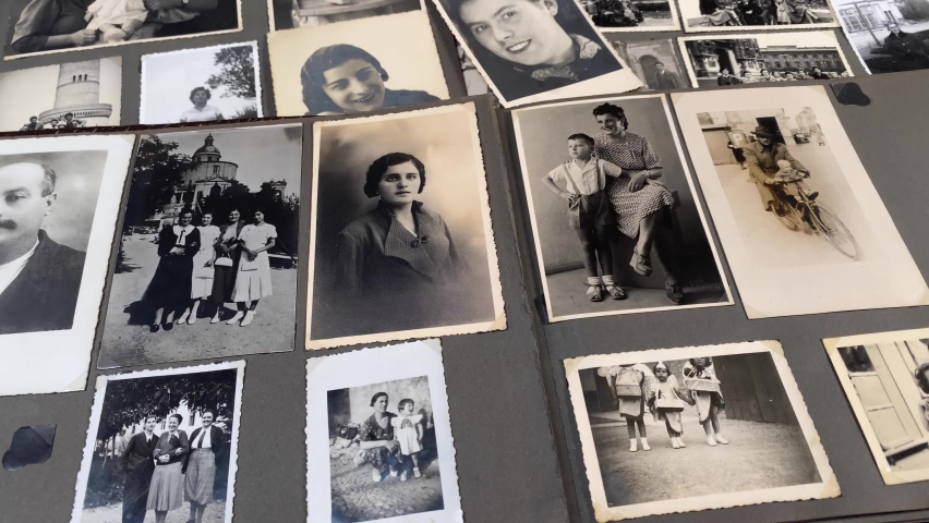 30-11-2021, Modena, Italy. Looking at vintage old  family photos. concept for passing the time, memories of the past, perception of time, resource under lockdown