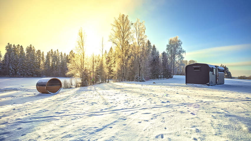Beautiful Time lapse shot of Winter Landscape with Wooden House and moving Sun against Blue sky in Background | Shutterstock HD Video #1081527497