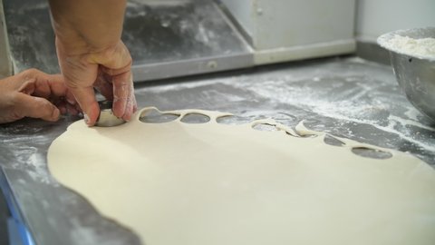dumplings, ravioli. dough for dumplings. Close-up. Cutting out circles from raw dough.