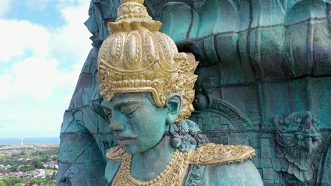Close up aerial view of Vishnu riding Garuda. Giant copper blue and green Garuda Wisnu Kencana statue in Bali, Indonesia
