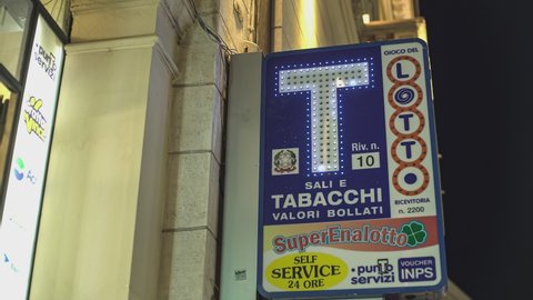 ROVIGO, ITALY 30 OCTOBER 2021: Illuminated Italian tobacconist sign at night
