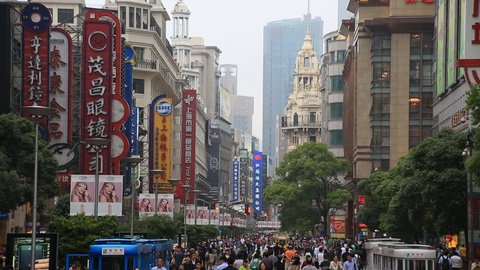  SHANGHAI, CHINA - CIRCA JUNE 2015 : Crowded visitors and travelers walking at Shanghai Nanjing Road in Shanghai, China. 
Nanjing Road is the most famous landmark of Shanghai, China 