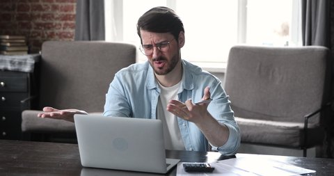 Frustrated man calculate finances sit at desk with bills, calculator and laptop, feel stressed about bank debt, late loan payment, experience bad financial situation, lack of money, bankruptcy concept