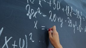 Female hand with chalk. Math faceless teacher writes examples for schoolchildren on blackboard. Student, pupil girl solves system of equations on chalkboard. Algebra, mathematics in classroom - Powered by Shutterstock - Get 15% off with code: PIKWIZARD15