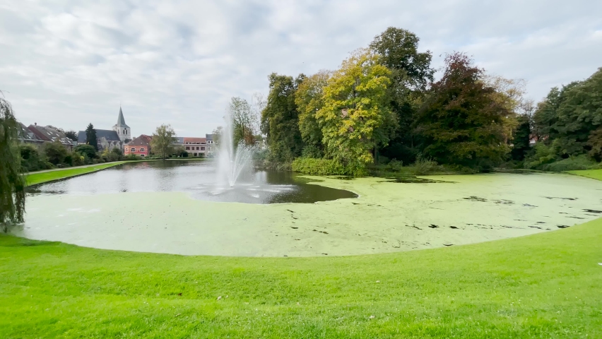 Water pond with a fountain in van Dilbeek Park in Brussels 