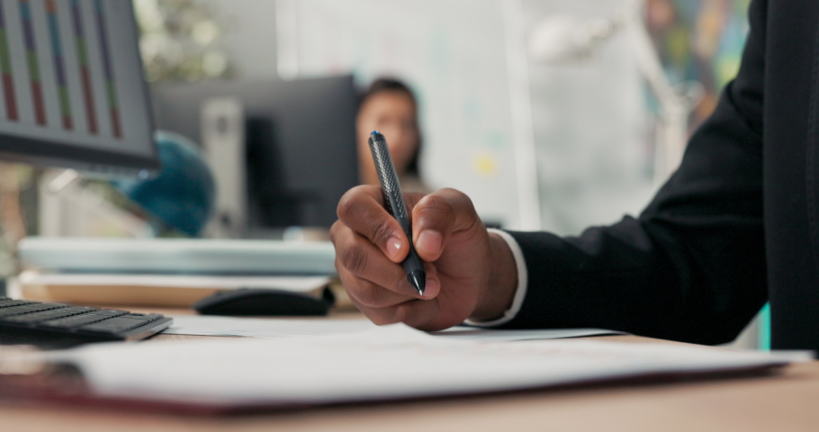 Close-up hand shot of dark-skinned man holding pen, signing documents, filling out application, cuffs of black suit, office scene, boss, manager, businessman gives consent, makes initial Royalty-Free Stock Footage #1081557812