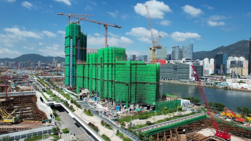 Commercial residential construction site in Kai Tak Cruise Terminal of Hong Kong city, Kwun Tong and Kowloon Bay near Victoria harbor, Aerial drone view | Shutterstock HD Video #1081560518