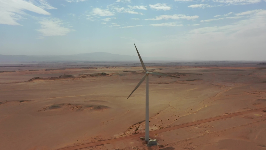 Aerial zoom in shot to Windmill in beautiful Egyptian desert Royalty-Free Stock Footage #1081560962