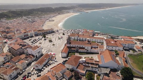 Sprawling white sand beach of Nazare, seaside resort town, Portugal. Panoramic aerial view