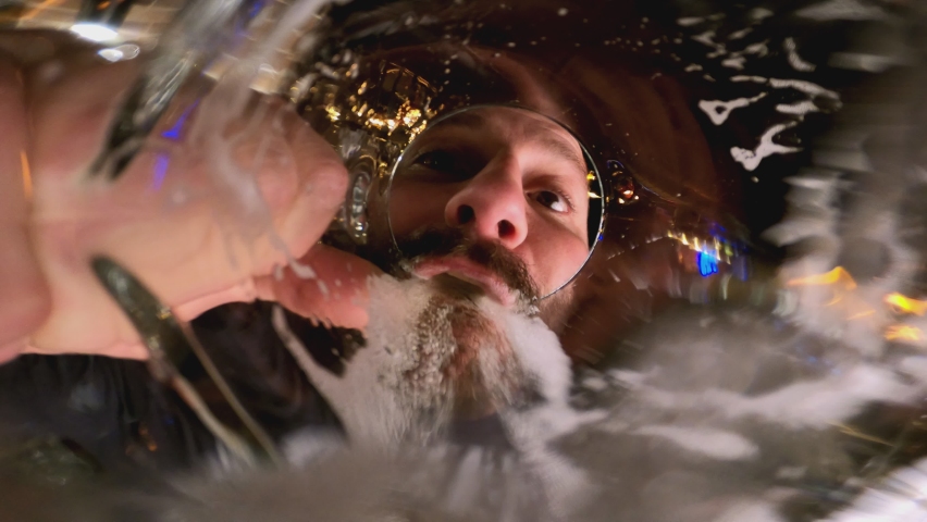 4k Beard man drinking beer or water . Beer pouring into mouth . Camera inside of beer glass or cup . Very funny angle view of camera . | Shutterstock HD Video #1081569584