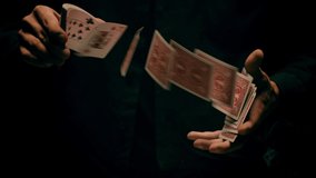 Close-up of a Magician's Hands Performing Card Trick . Throwing and Catching Cards in the Air on black Background with smoke . Card Mechanic .  Shot on ARRI Alexa cinema camera in Slow Motion  - Powered by Shutterstock - Get 15% off with code: PIKWIZARD15
