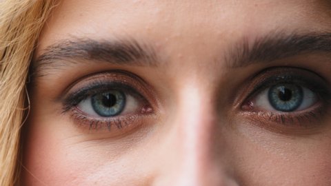Close up female beautiful blue clear eyes young caucasian girl looking at camera woman with good vision sight eyesight with long eyelashes make-up look see after successful laser surgery ophthalmology