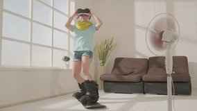 Woman in virtual reality glasses slide on snowboard in living room, simulated snowboarding using modern technology.