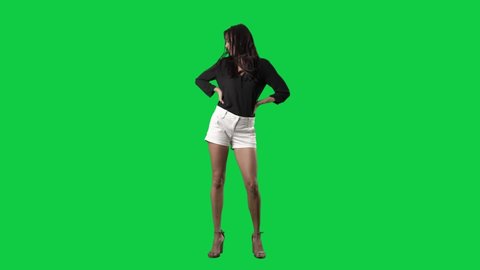 Slow motion of long hair brunette shaking head and tossing hair having fun. Full body isolated on green screen background