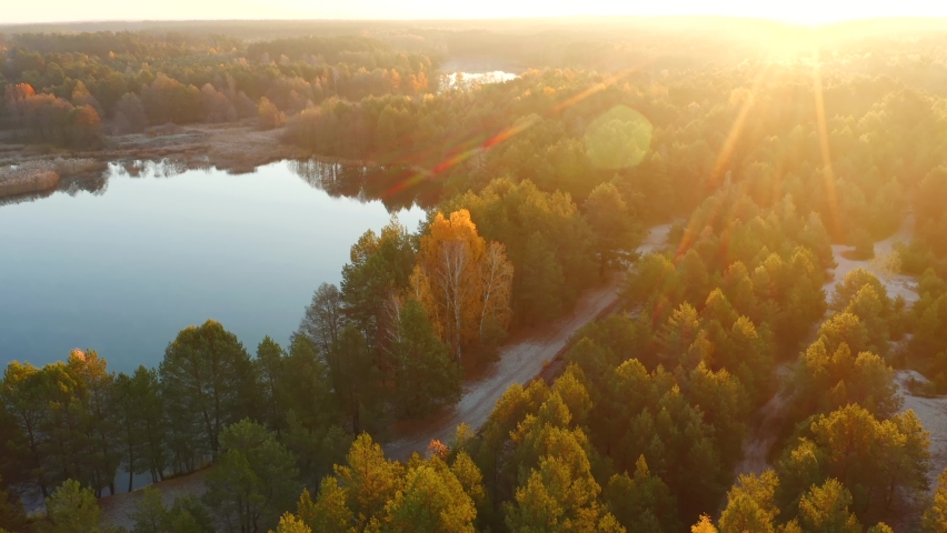Magical view from a drone on a calm lake at dawn. Bird