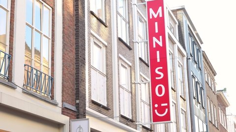 Eindhoven, The Netherlands, October 29 2021. Miniso retail store sign in the centre with low cost Chinese goods from a popular Asian franchise chain. New business