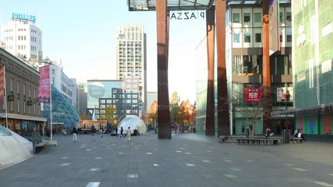 Eindhoven, The Netherlands, October 29 2021. Square in the city centre on the 18 Septemberplein with people walking on a sunny morning during fall