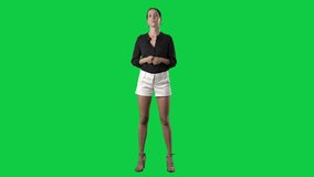 Happy young elegant woman showing and presenting copy space. Full body isolated on green screen background
