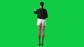 Back view of elegant stylish woman using invisible touch screen technology. Full body isolated on green screen background - Powered by Shutterstock - Get 15% off with code: PIKWIZARD15