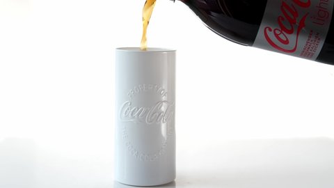 Frankfurt, Germany, October 2021: close-up of white glass from the Coca-Cola Company, brand name is highlighted, plastic soda bottle with gray label, low sugar, soft drinks concept