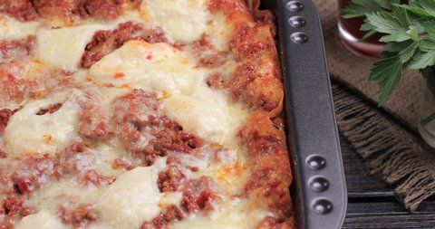 Homemade fresh lasagna in the pan presentation. Cooking home concept. Dolly shot 4k