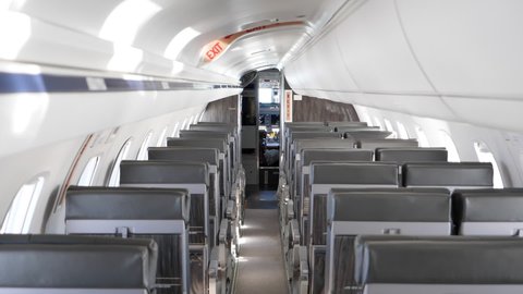 View Inside Economy Airplane With Rows Of Empty Seats. Aircraft Interior. high angle, dolly-in