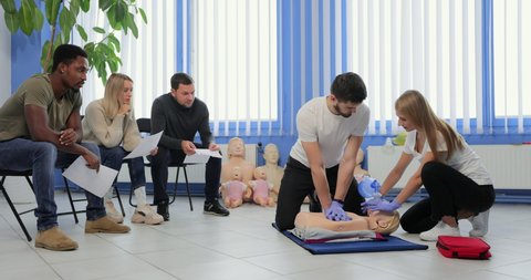 Male instructor teaching first Aid Cpr technique to his students.
