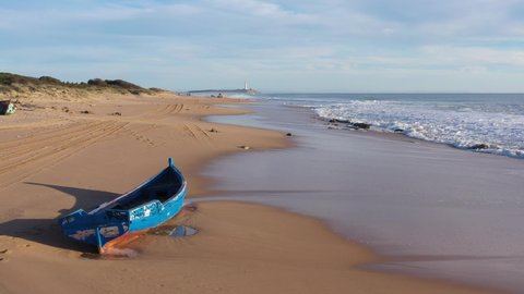 Dinghy boat stranded on an Ansalusian beach in south Spain