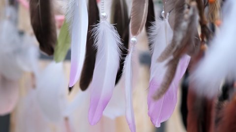Beautiful multicolored feathers from Dreamcatcher amulets flying and swinging in the wind. 50 fps.