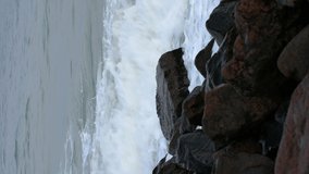 Vertical video Huge waves wash over the rocky shore. - Powered by Shutterstock - Get 15% off with code: PIKWIZARD15