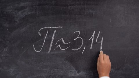 The teacher's hand writes the number Pi = 3.14 on the blackboard