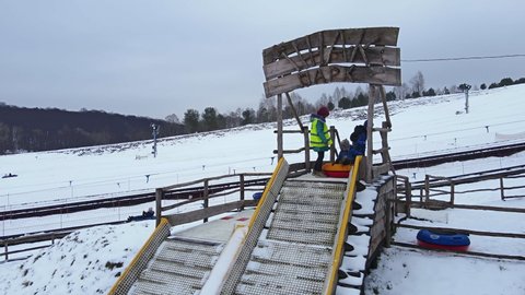 Lviv, Ukraine - January 30, 2021: families having fun at snow tubing park aerial view Szerkesztői stockvideó