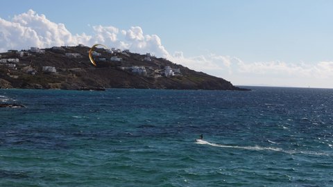 Kitesurfer Kiteboarding on Agios Ioannis Beach, Mykonos, Greece in the Mediterranean Sea