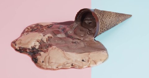 Zoom in Ice Cream Cone Chocolate Melting isolated on the floor blue and pink background.
