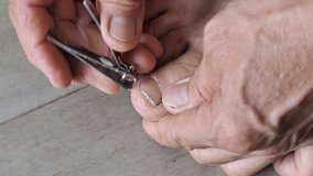 Adult man are using nail clipper clipping toenail