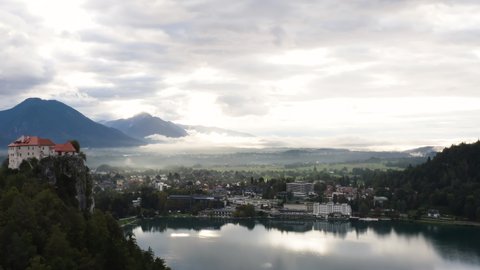 Aerial View Of Bled Castle (Blejski Grad) With Lush Forest Along Lake Bled And City In Slovenia.