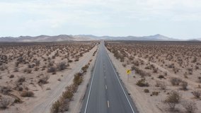 Desert road. Aerial point of view over road in desert. Panoramic landscape of Death Valley in USA. 4k Aerial Video - Desert Death Valley. 