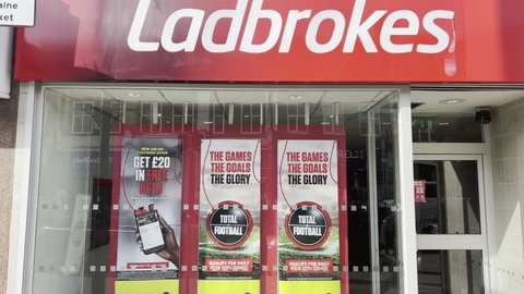 London UK - October 26th 2021 - Camera pans up Ladbrokes exterior in Palmers Green. Ladbrokes Coral is a British betting and gambling company based in London.
