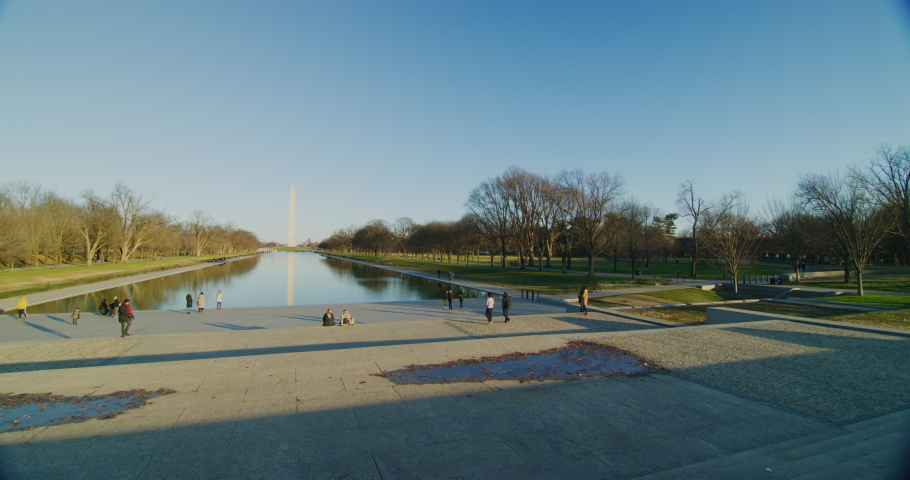 Tourists at the Lincoln Memorial looking towards the Washington Monument and reflecting pool during winter time. Red Helium camera-8k resolution-vintage Zeiss lenses in Washington DC.