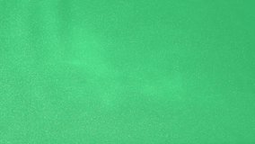 Slow motion water surface texture splashes, ripples isolated on green background